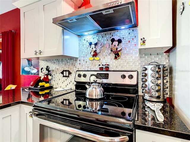 550 Canary Island Cir, Davenport, FL 33837 - kitchen featuring stainless steel range with electric cooktop, extractor fan, white cabinetry, and backsplash