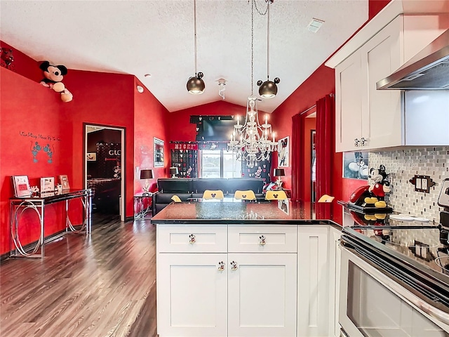 550 Canary Island Cir, Davenport, FL 33837 - kitchen with stainless steel range with electric stovetop, wall chimney range hood, a peninsula, lofted ceiling, and wood finished floors