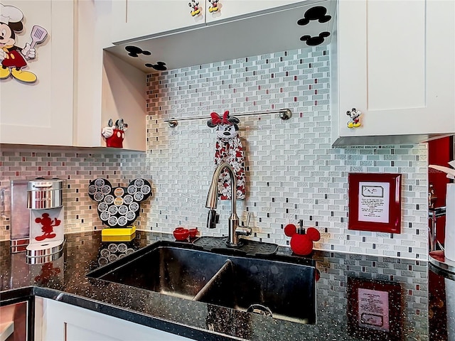 550 Canary Island Cir, Davenport, FL 33837 - kitchen featuring a sink, white cabinetry, decorative backsplash, and dark stone countertops