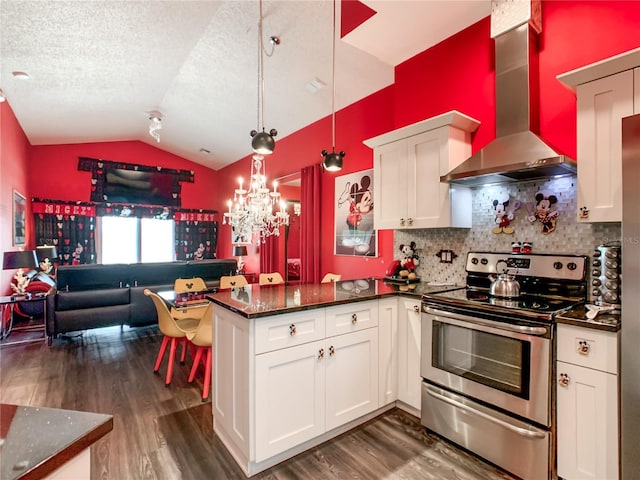 550 Canary Island Cir, Davenport, FL 33837 - kitchen featuring stainless steel range with electric cooktop, wall chimney range hood, dark wood-style floors, vaulted ceiling, and a peninsula