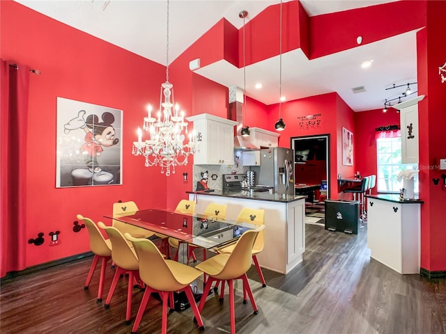 550 Canary Island Cir, Davenport, FL 33837 - dining area featuring dark wood finished floors, a high ceiling, a chandelier, and baseboards