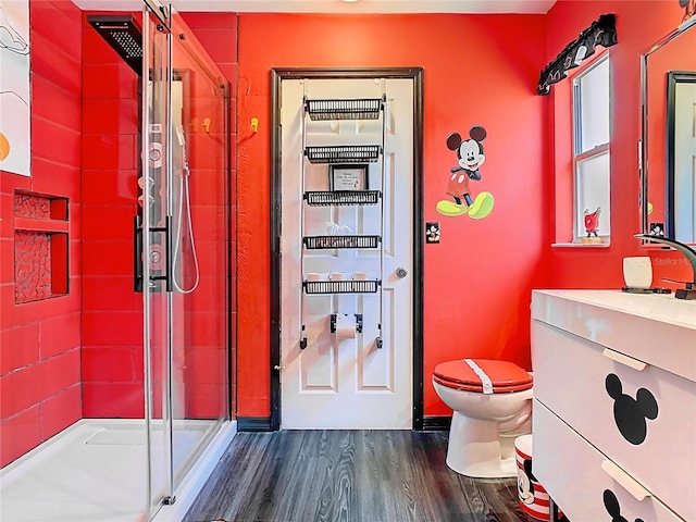 550 Canary Island Cir, Davenport, FL 33837 - bathroom with a shower stall, toilet, wood finished floors, and vanity