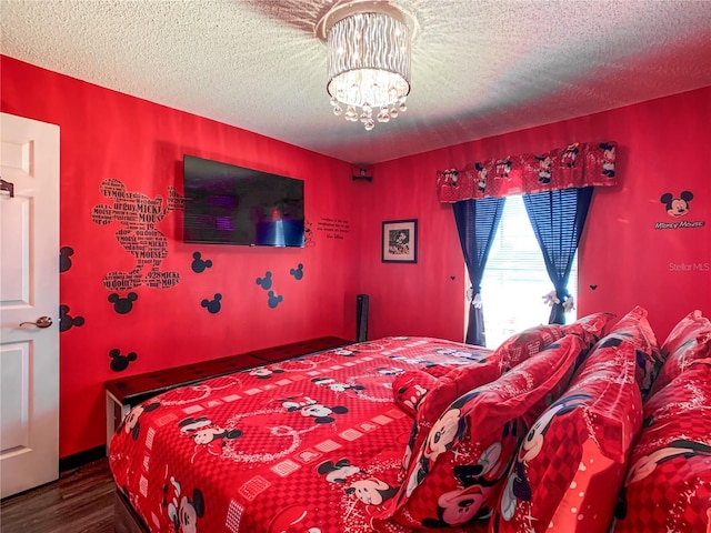 550 Canary Island Cir, Davenport, FL 33837 - bedroom featuring a chandelier, wood finished floors, and a textured ceiling
