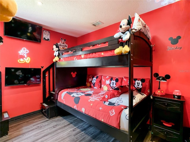 550 Canary Island Cir, Davenport, FL 33837 - bedroom with wood finished floors and a textured ceiling
