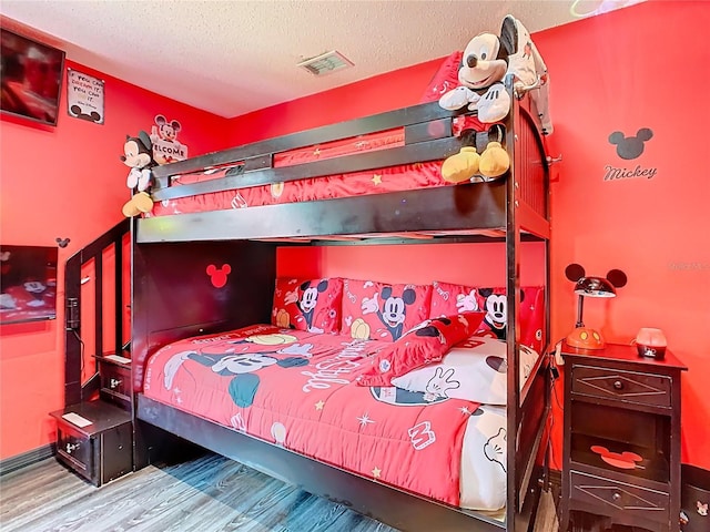 550 Canary Island Cir, Davenport, FL 33837 - bedroom featuring wood finished floors and a textured ceiling
