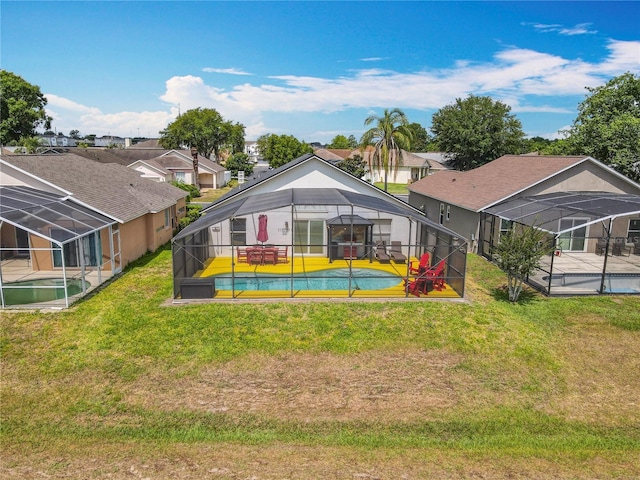 550 Canary Island Cir, Davenport, FL 33837 - rear view of property featuring an outdoor pool, glass enclosure, a yard, and a patio