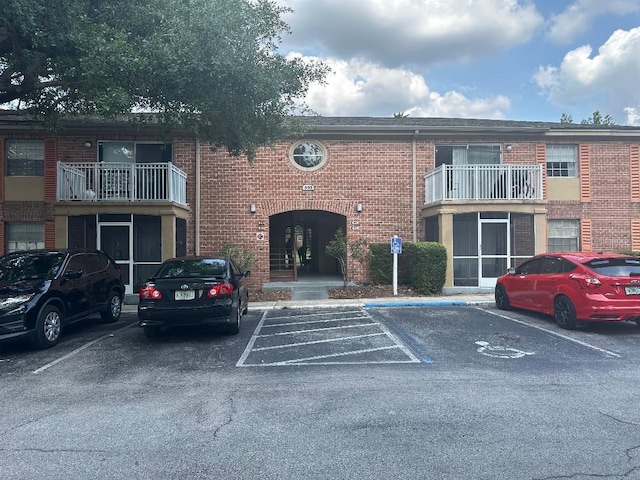 view of building exterior featuring uncovered parking