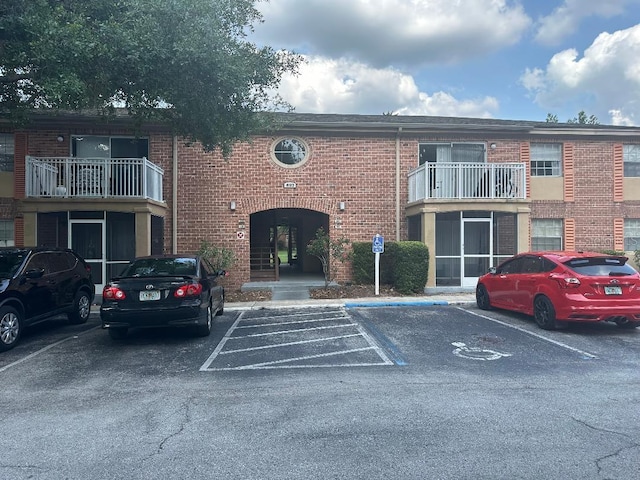 view of building exterior featuring uncovered parking