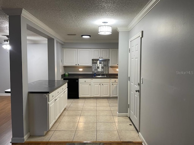 kitchen with ornamental molding, a sink, dark countertops, a textured ceiling, and black dishwasher