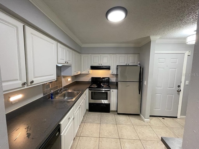 kitchen with appliances with stainless steel finishes, under cabinet range hood, a sink, dark countertops, and white cabinetry