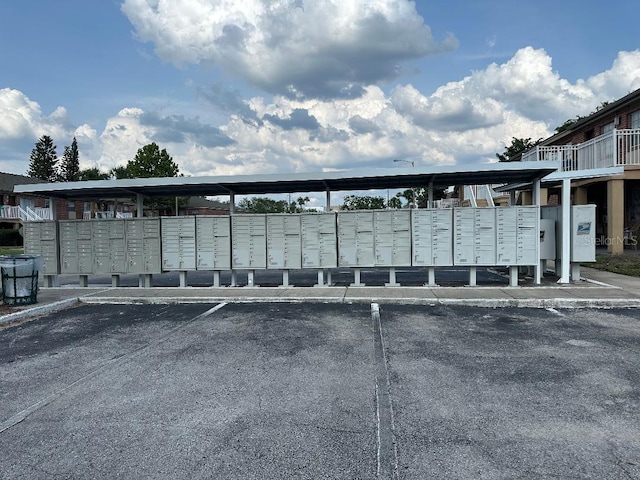 exterior view of mail area and a parking lot
