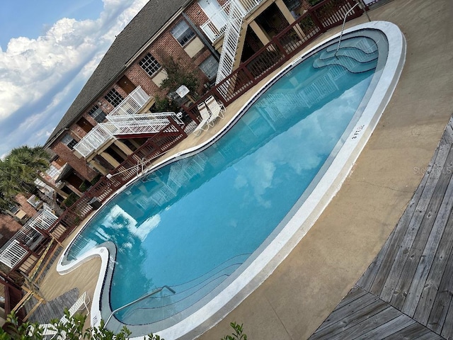 community pool featuring a water slide