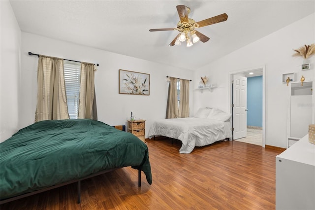 bedroom featuring vaulted ceiling, wood finished floors, and ceiling fan