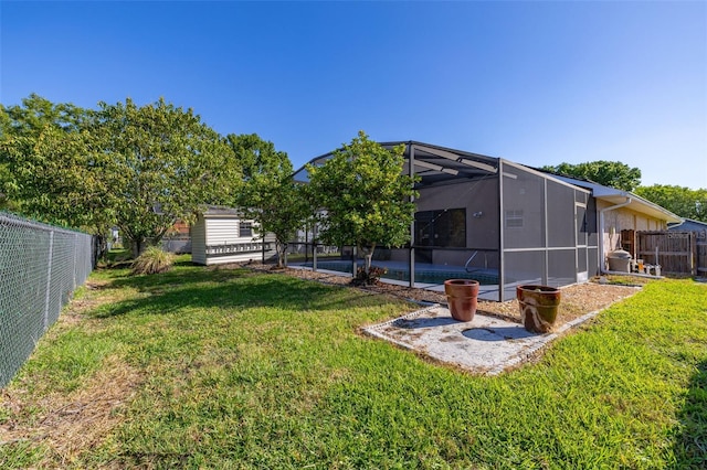 view of yard featuring a patio and a lanai