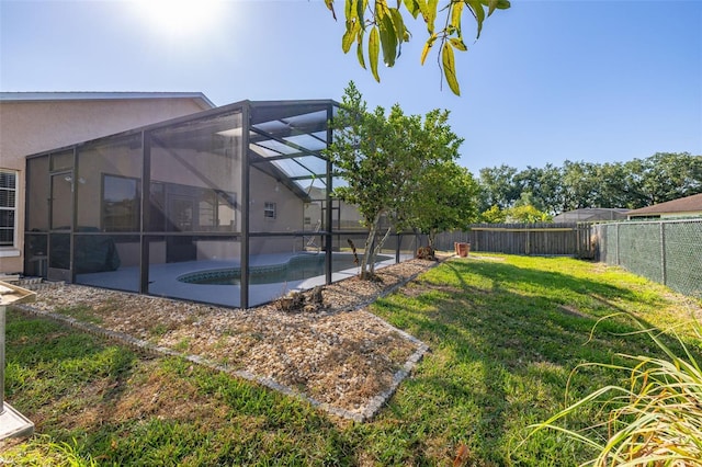 view of yard featuring a patio and a lanai