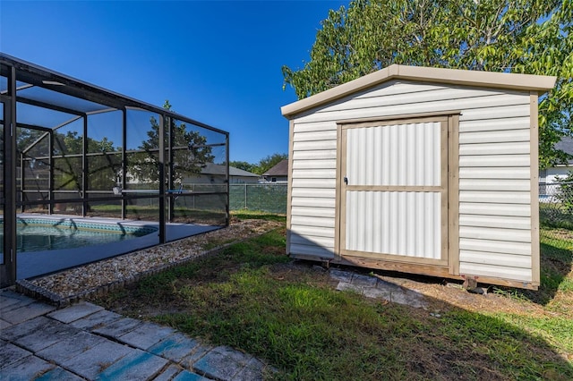 view of shed with a fenced backyard and an outdoor pool