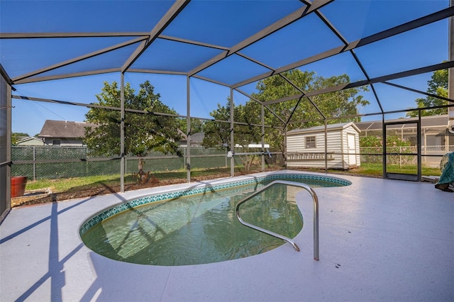 view of swimming pool with a shed, a patio area, an outbuilding, and a fenced backyard