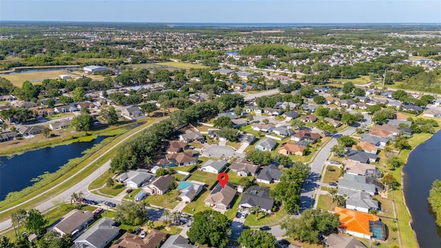 view of property location with a nearby body of water and nearby suburban area