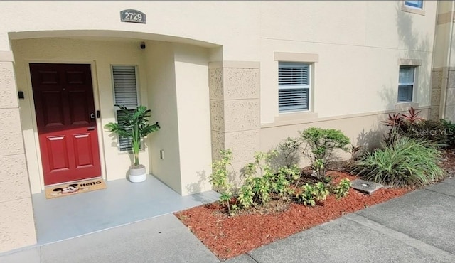 2729 Club Cortile Cir, Kissimmee, FL 34746 - view of exterior entry featuring stucco siding