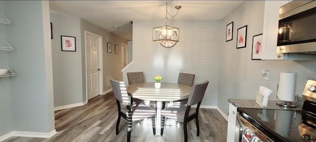 2729 Club Cortile Cir, Kissimmee, FL 34746 - dining space featuring wood finished floors, baseboards, and a chandelier