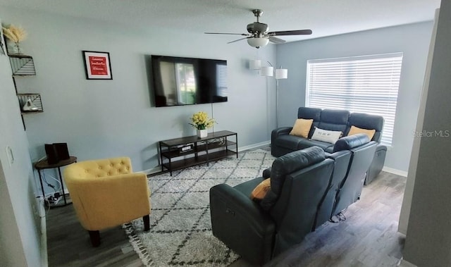 2729 Club Cortile Cir, Kissimmee, FL 34746 - living room featuring a ceiling fan, wood finished floors, and baseboards