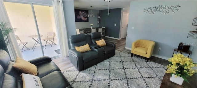 2729 Club Cortile Cir, Kissimmee, FL 34746 - living area with wood finished floors, baseboards, and a chandelier