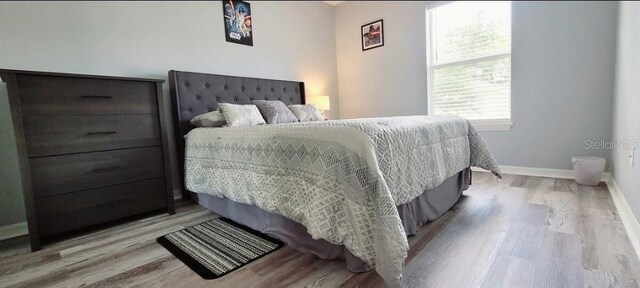 2729 Club Cortile Cir, Kissimmee, FL 34746 - bedroom featuring wood finished floors and baseboards