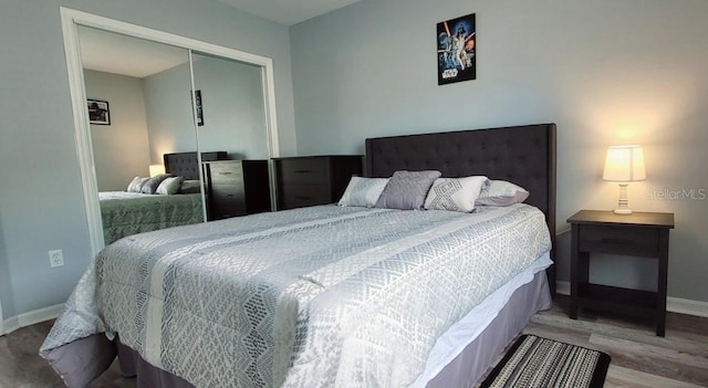 2729 Club Cortile Cir, Kissimmee, FL 34746 - bedroom featuring a closet, wood finished floors, and baseboards