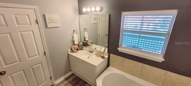 2729 Club Cortile Cir, Kissimmee, FL 34746 - full bathroom featuring healthy amount of natural light, a garden tub, and vanity