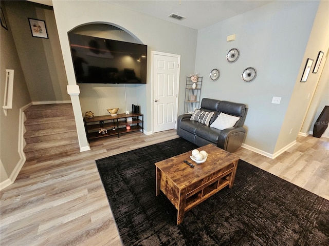 2531 Old Kent Cir, Kissimmee, FL 34758 - living room with wood finished floors, baseboards, and stairway