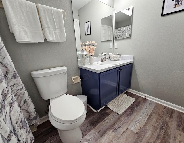 2531 Old Kent Cir, Kissimmee, FL 34758 - full bathroom featuring wood finished floors, toilet, vanity, and baseboards