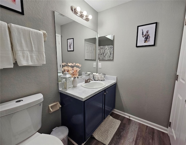 2531 Old Kent Cir, Kissimmee, FL 34758 - bathroom with wood finished floors, toilet, vanity, and baseboards