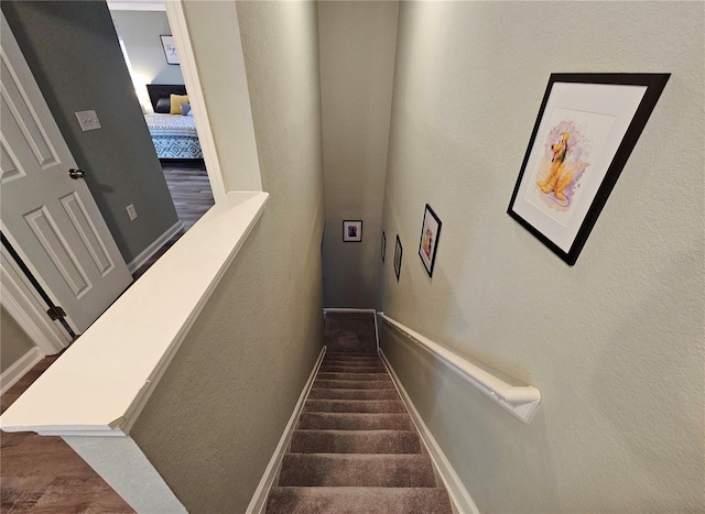 2531 Old Kent Cir, Kissimmee, FL 34758 - staircase with baseboards, a textured wall, and wood finished floors