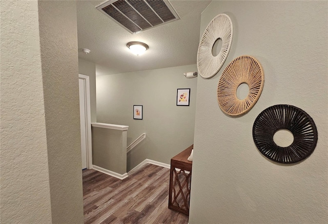 2531 Old Kent Cir, Kissimmee, FL 34758 - hall with an upstairs landing, wood finished floors, a textured wall, baseboards, and a textured ceiling