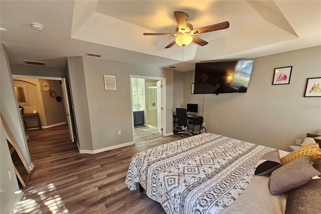 2531 Old Kent Cir, Kissimmee, FL 34758 - bedroom with a raised ceiling, wood finished floors, baseboards, and ensuite bathroom