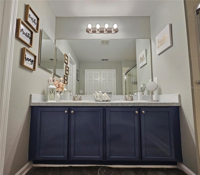 2531 Old Kent Cir, Kissimmee, FL 34758 - bathroom with a stall shower, double vanity, and baseboards