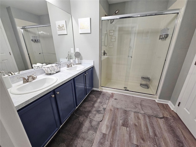 2531 Old Kent Cir, Kissimmee, FL 34758 - bathroom with wood finished floors, a shower stall, and double vanity