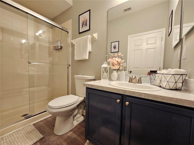 2531 Old Kent Cir, Kissimmee, FL 34758 - full bathroom with toilet, wood finished floors, a shower stall, and vanity