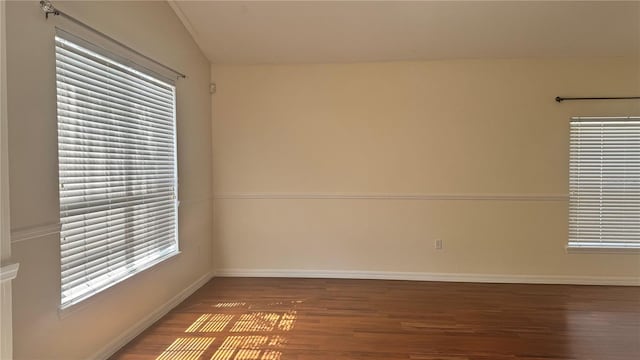 979 Hacienda Cir, Kissimmee, FL 34741 - spare room with wood finished floors, baseboards, and vaulted ceiling