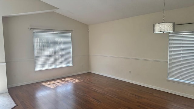 979 Hacienda Cir, Kissimmee, FL 34741 - unfurnished room featuring wood finished floors, baseboards, and vaulted ceiling