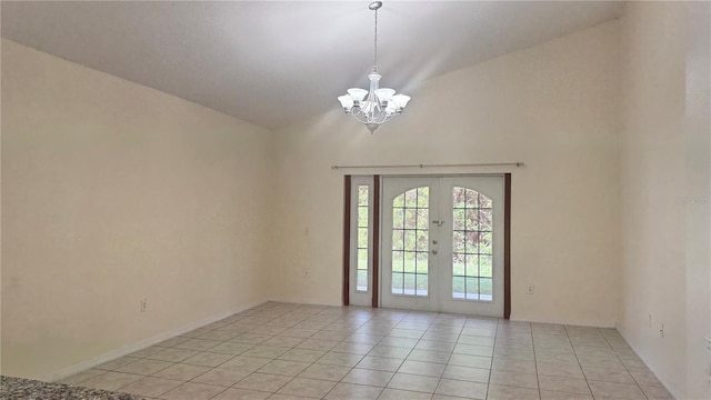 979 Hacienda Cir, Kissimmee, FL 34741 - unfurnished room featuring a chandelier, light tile patterned floors, high vaulted ceiling, and french doors
