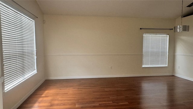 979 Hacienda Cir, Kissimmee, FL 34741 - empty room featuring wood finished floors, plenty of natural light, and baseboards