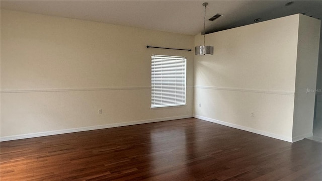 979 Hacienda Cir, Kissimmee, FL 34741 - empty room with vaulted ceiling, dark wood finished floors, and baseboards