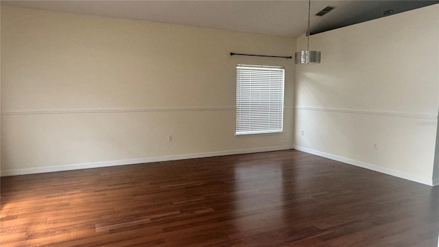 979 Hacienda Cir, Kissimmee, FL 34741 - empty room with dark wood-type flooring, vaulted ceiling, and baseboards