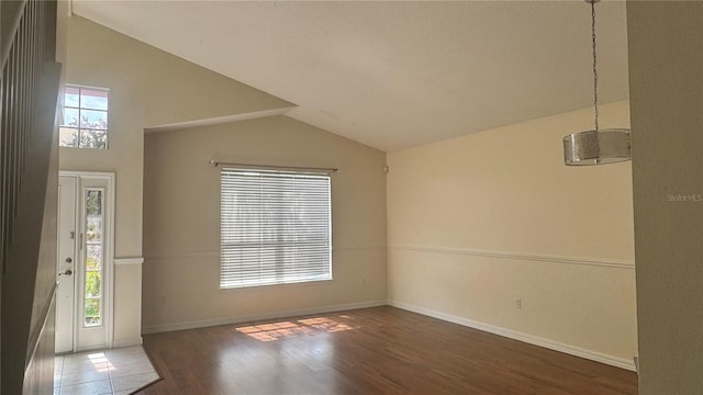 979 Hacienda Cir, Kissimmee, FL 34741 - foyer entrance featuring vaulted ceiling, wood finished floors, and baseboards