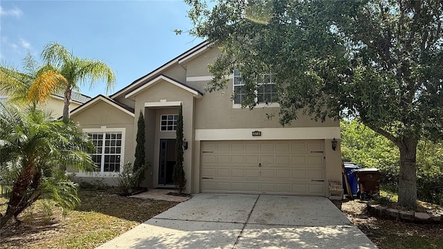 979 Hacienda Cir, Kissimmee, FL 34741 - view of front of house with stucco siding, driveway, and an attached garage
