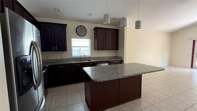 979 Hacienda Cir, Kissimmee, FL 34741 - kitchen featuring stainless steel fridge with ice dispenser, a sink, light tile patterned floors, a center island, and vaulted ceiling