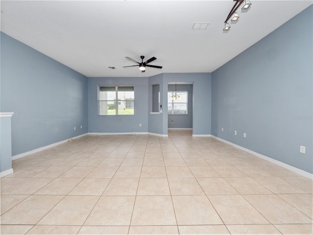 empty room featuring ceiling fan, baseboards, and light tile patterned flooring
