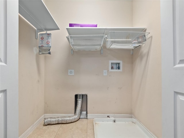 washroom with hookup for an electric dryer, hookup for a washing machine, tile patterned floors, and baseboards