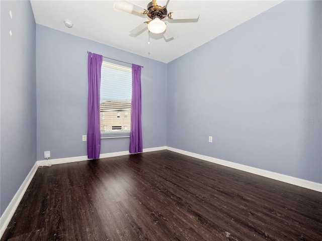 spare room featuring wood finished floors, baseboards, and a ceiling fan